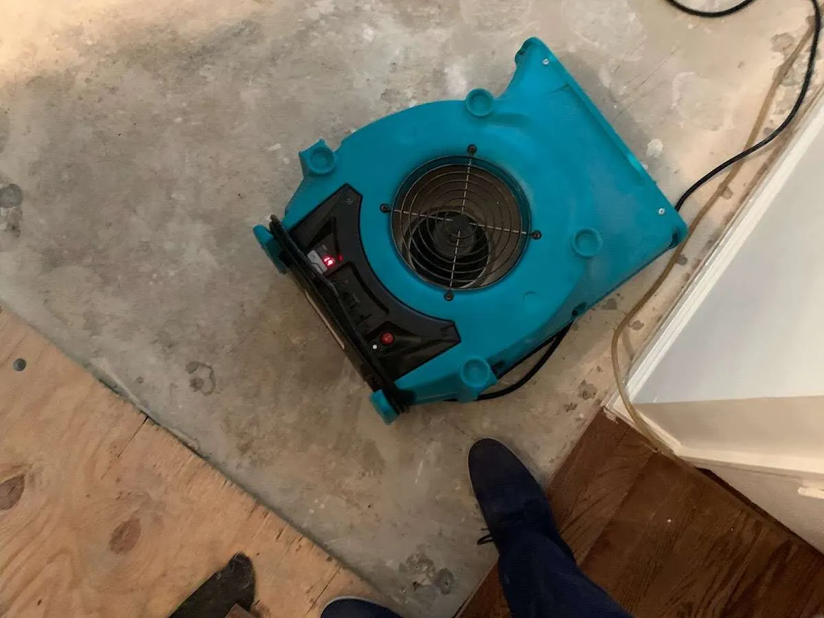 Air mover drying subfloor during Commercial Water Damage Restoration in Miami Gardens